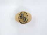 a gold signet ring with the letter l on it