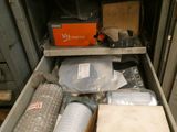 a drawer with many items in it in a room