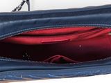 purse with red lining inside of it on a white surface