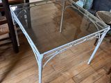 a glass table and chairs in a room with a fireplace