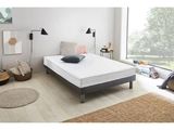 un lit sur lequel est posé un matelas dans une pièce