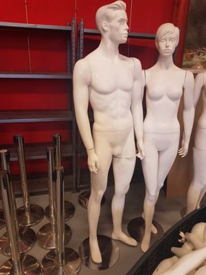 three mannequins that are standing in a room