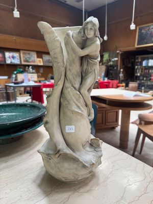 a statue that is sitting on a table in a store