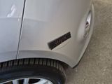 a silver car with a sticker on the side of it
