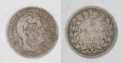 a close up of two silver coins on a white surface