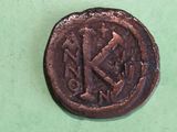 a close up of a coin on a green surface