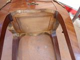 a wooden chair that is sitting on a hard wood floor