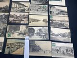 several old black and white photographs of people and vehicles on display
