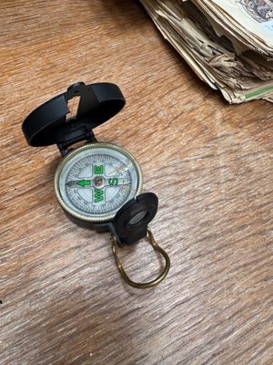 a compass on a table with money on the table