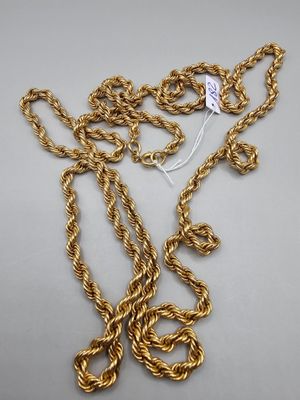 a close up of a gold chain with a tag on it