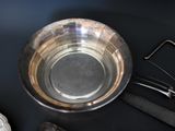 a silver bowl and a pair of scissors on a table