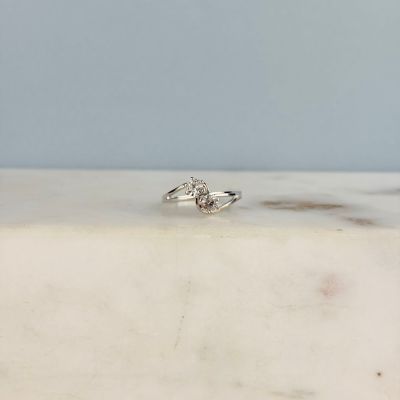 une photo d'une bague en diamant posée sur une surface en marbre
