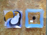 two square plates with a toucan on them on a table