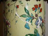 a vase with a floral design on it sitting on a table
