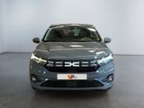 the front view of a grey car in a showroom