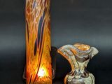 two vases sitting next to each other on a table
