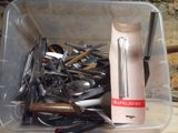 a plastic container filled with many different types of kitchen utensils