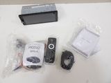 a remote control, a remote control, and other electronics on a table