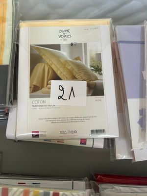 many sheets of paper on a table with a price tag