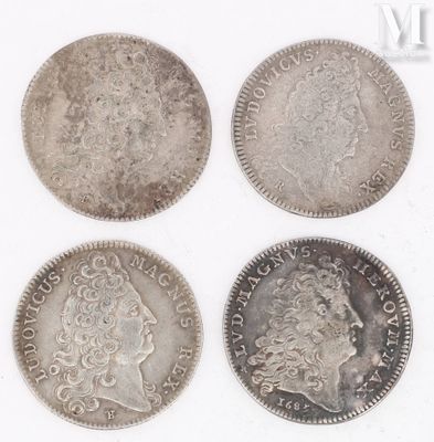four different types of silver coins on a white surface