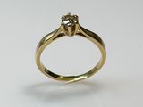 a close up of a diamond ring on a white surface