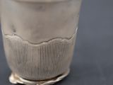 a silver cup that is sitting on a table