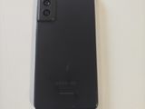 a close up of a cell phone on a white surface