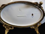 a white and gold plate with a gold rim
