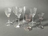 several wine glasses are lined up in a row on a gray surface