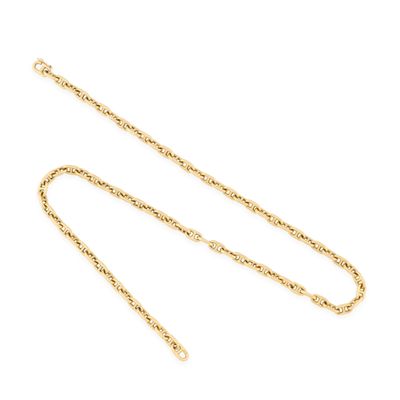a gold chain with a long link on a white background