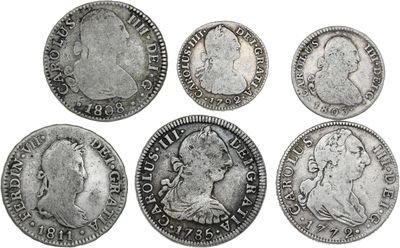 a group of six silver coins of various sizes and shapes