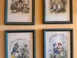 four framed pictures of people on a wall hanging on a wall