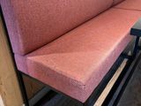 a bench with a red cushion on it in a room