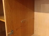 a wooden cabinet with a metal handle in the corner