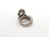 silver ring with two rings on top of each other on a white surface