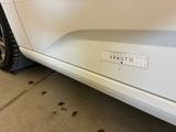 a white car that has a sticker on the side of it