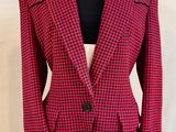 a close up of a red and black jacket on a mannequin dummy