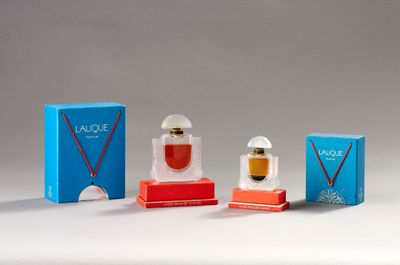three small perfume bottles are sitting next to each other on a table
