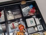 a black case with many different types of perfumes in it