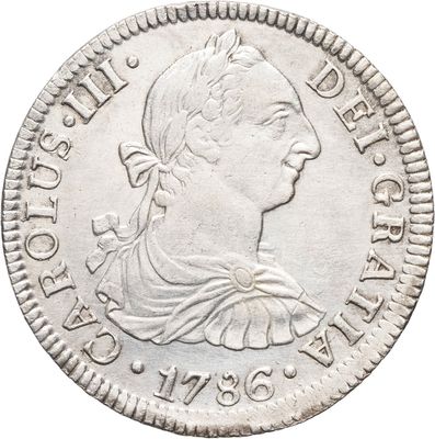 une pièce en argent avec l'image d'une femme de profil