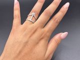 a woman ' s hand with a silver ring on it ' s finger