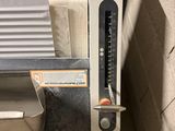 a machine that is sitting on the floor next to a wall