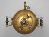 an image of a brass object hanging on a wall