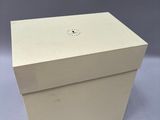 a white cardboard box with the lid open on a grey background
