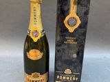 a bottle of champagne sitting next to a box of wine