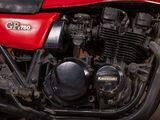 a close up of a red motorcycle parked on the street