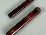 pair of antique chinese style wooden chopsticks on a white surface