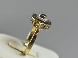 a close up of a gold ring with a blue stone in it
