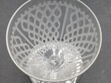 a clear glass bowl with a lacy design on it