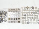 a lot of coins in a plastic bag on the table